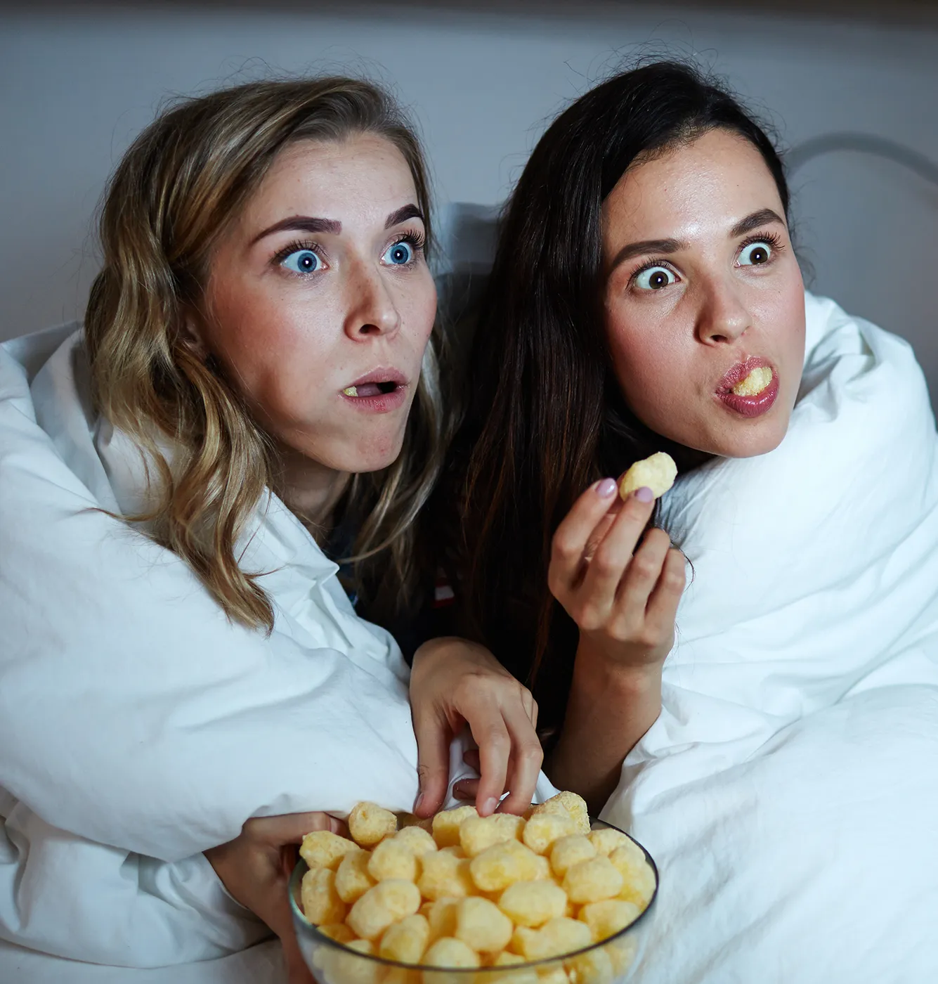 Two friends snuggle up to enjoy exciting TV moments and top-class entertainment.